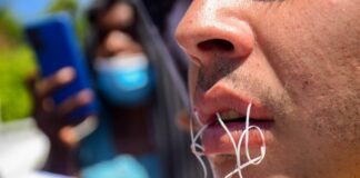 Migrantes se cosen los labios